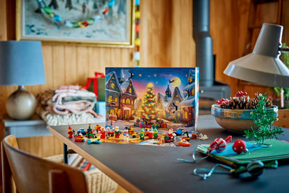 Christmas advent calendar box filled with small colorful toy figures sits